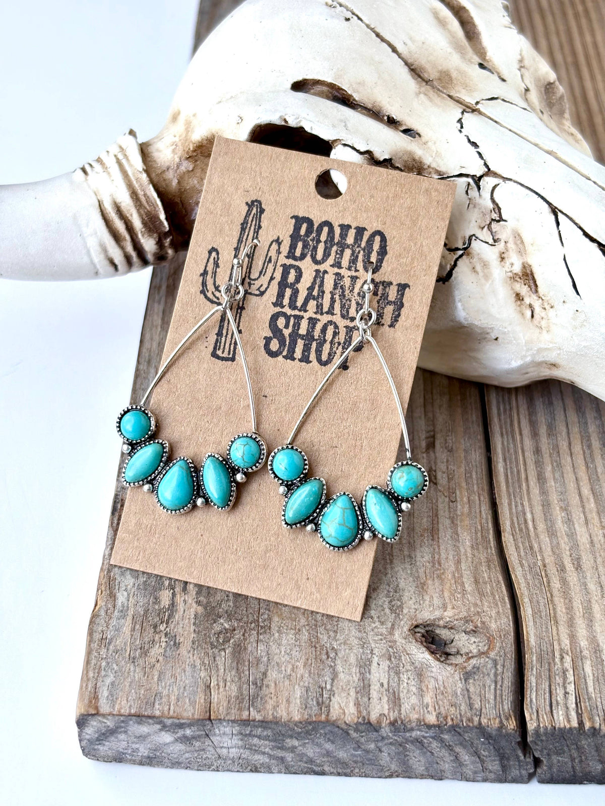 Turquoise teardrop hoop drop earrings with silver-tone western detailing and multiple turquoise-look stones