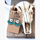 Turquoise western drop earrings featuring playing card designs and turquoise-inspired stone accents displayed on a rustic heart-shaped tray