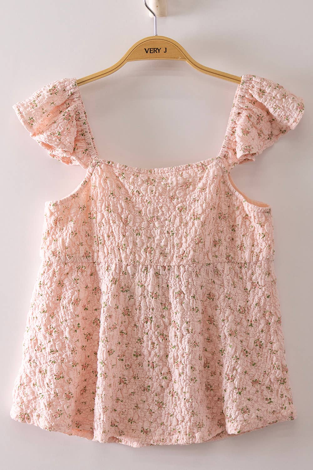 Blushing Prairie floral babydoll top available in blush and white with ruffle flutter sleeves and feminine tie-front neckline.