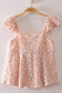 Blushing Prairie floral babydoll top available in blush and white with ruffle flutter sleeves and feminine tie-front neckline.