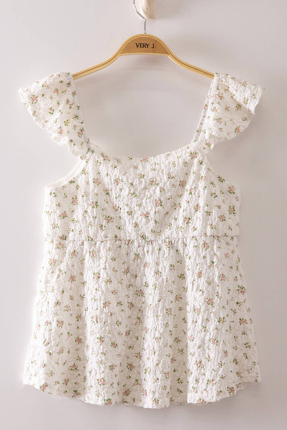 Blushing Prairie floral babydoll top available in blush and white with ruffle flutter sleeves and feminine tie-front neckline.