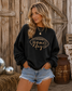 Women's embroidered Game Day corduroy sweatshirt available in Beige and Black with football graphic and relaxed fit.