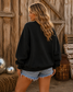 Women's embroidered Game Day corduroy sweatshirt available in Beige and Black with football graphic and relaxed fit.