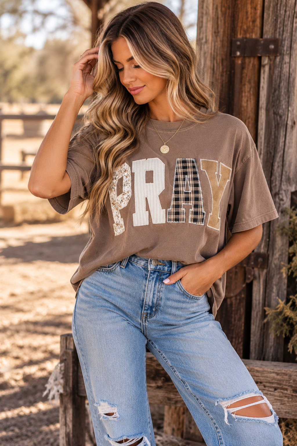 Neutral washed short sleeve PRAY graphic tee with oversized mixed-pattern patchwork lettering