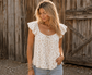 Blushing Prairie floral babydoll top available in blush and white with ruffle flutter sleeves and feminine tie-front neckline.