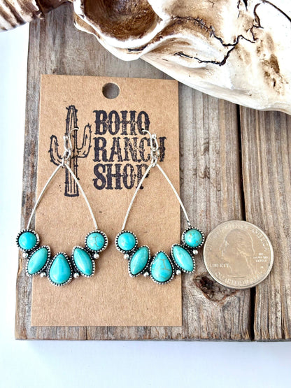 Turquoise teardrop hoop drop earrings with silver-tone western detailing and multiple turquoise-look stones