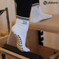 White Tiny Bit Hotter martini grip socks with contrast striped cuffs, cocktail embroidery and black heart-shaped non-slip grips.