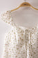 Blushing Prairie floral babydoll top available in blush and white with ruffle flutter sleeves and feminine tie-front neckline.