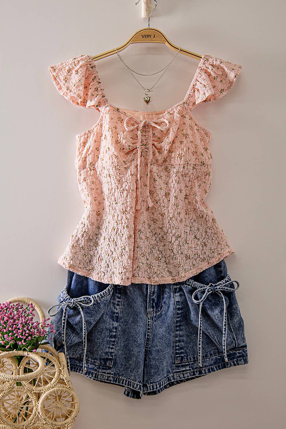 Blushing Prairie floral babydoll top available in blush and white with ruffle flutter sleeves and feminine tie-front neckline.