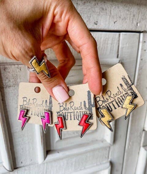 Western lightning bolt stud earrings with silver-tone detailing in pink, white and assorted colors displayed on boutique jewelry cards