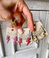 Western lightning bolt stud earrings with silver-tone detailing in pink, white and assorted colors displayed on boutique jewelry cards