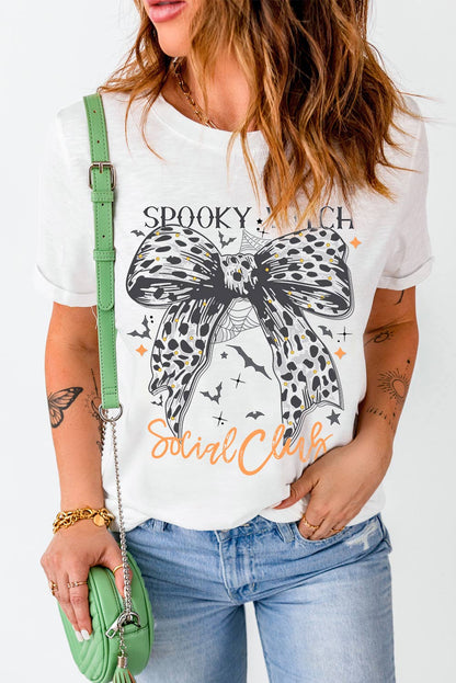 Halloween spooky witch social tee with witch graphic and leopard bow, styled with jeans for festive flair.